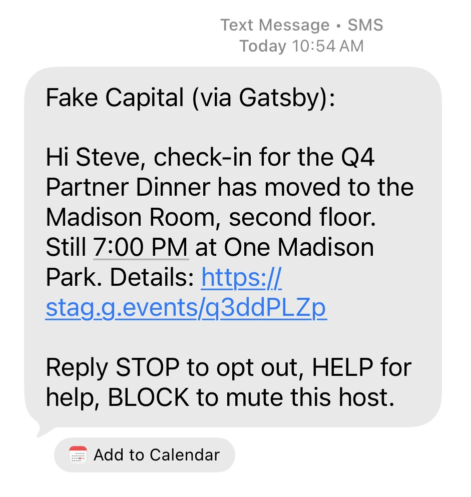 A text message on a phone, headed Text Message SMS. It reads Fake Capital (via Gatsby), then Hi Steve, check-in for the Q4 Partner Dinner has moved to the Madison Room, second floor. Still 7:00 PM at One Madison Park. Details, followed by a shortened link. The last line reads Reply STOP to opt out, HELP for help, BLOCK to mute this host.